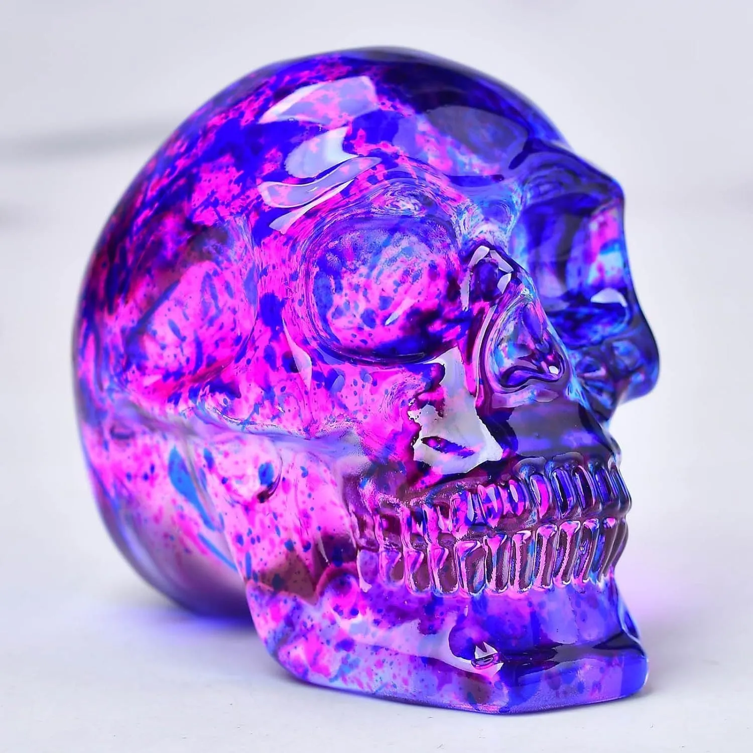 Pink and blue floral skull ornament made of glass with hanging loop
