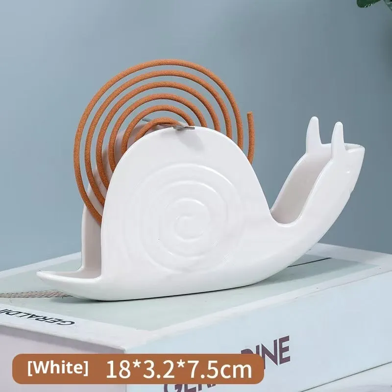 Black plastic universal mosquito incense holder on a table, simple portable design with creative animal style