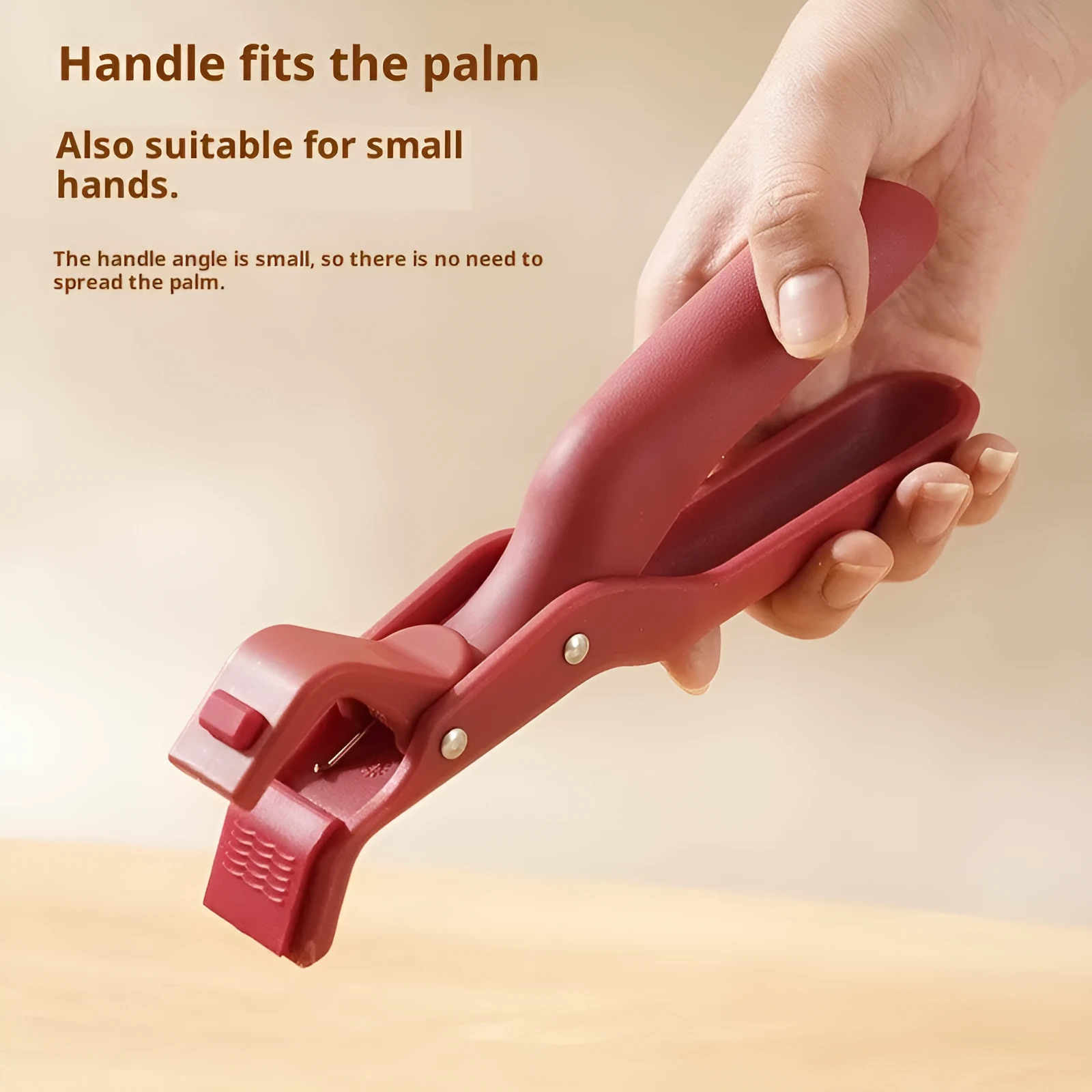 Creative household kitchen silicone anti-scalding clip in carmine colour on a table with a nearby pot