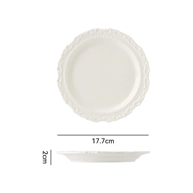 Cream ceramic vintage lace plate with irregular shape and glazed finish in white