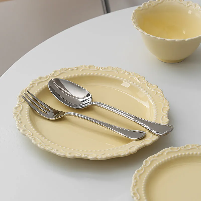 Cream ceramic vintage lace plate with irregular shape and glazed finish in white