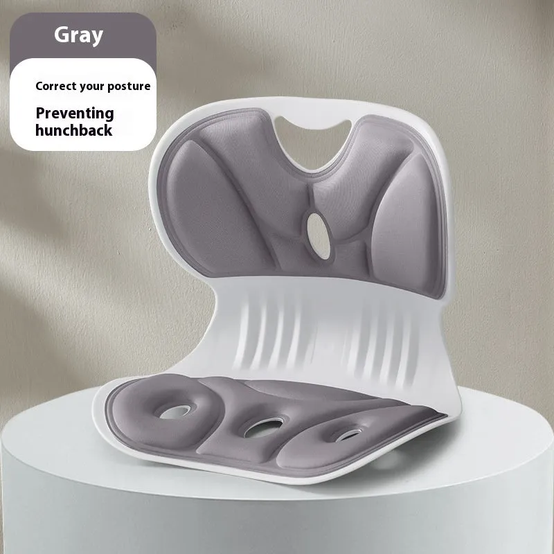 Memory foam chair cushion in grey on a wooden chair, showing lumbar support and minimalist solid colour design.