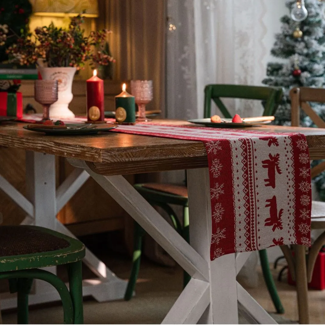 Home Christmas jacquard table runner in polyester cotton with jacquard red deer flat hem design on a table setting