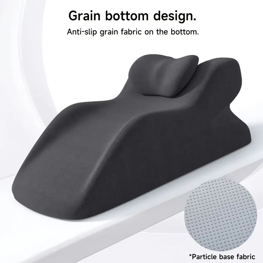 A prone position stomach sleeping pillow shown in a light grey colour, designed for use while reading in bed.