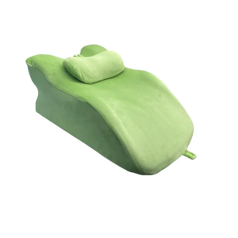 A prone position stomach sleeping pillow shown in a light grey colour, designed for use while reading in bed.