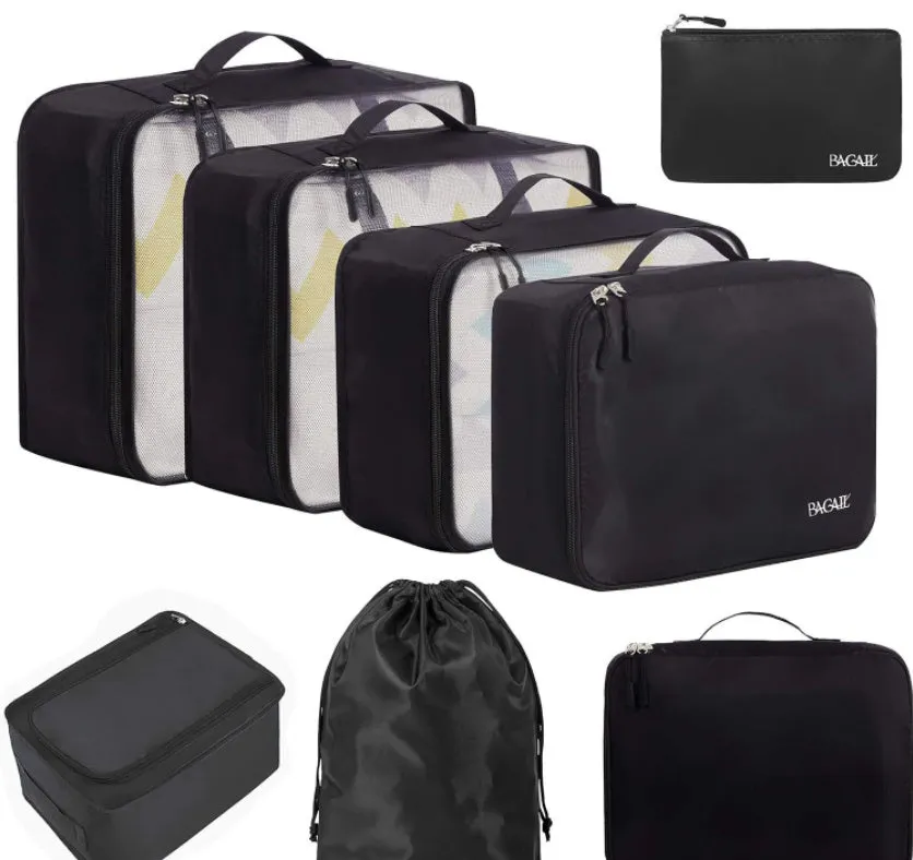 Set of eight cubic packing organisers in assorted solid colours including beige, black, and pink.