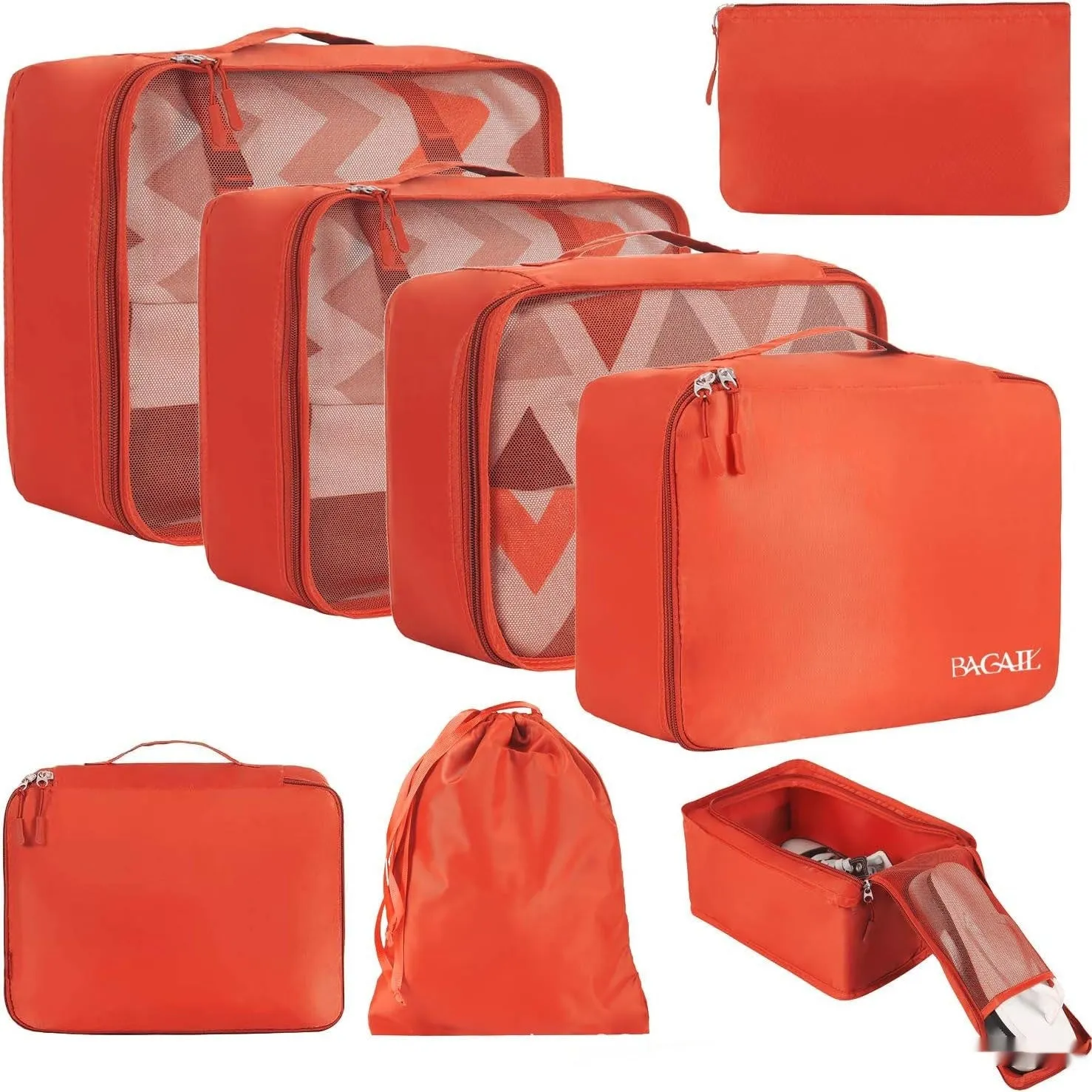 Set of eight cubic packing organisers in assorted solid colours including beige, black, and pink.