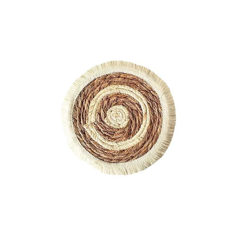 Round Japanese straw placemat with tassel edge on dining table