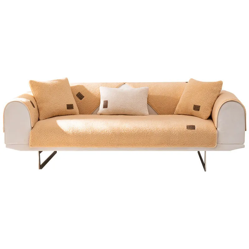 Solid colour lambswool sofa cover draped over a sofa, showing simple style and cloth liner.