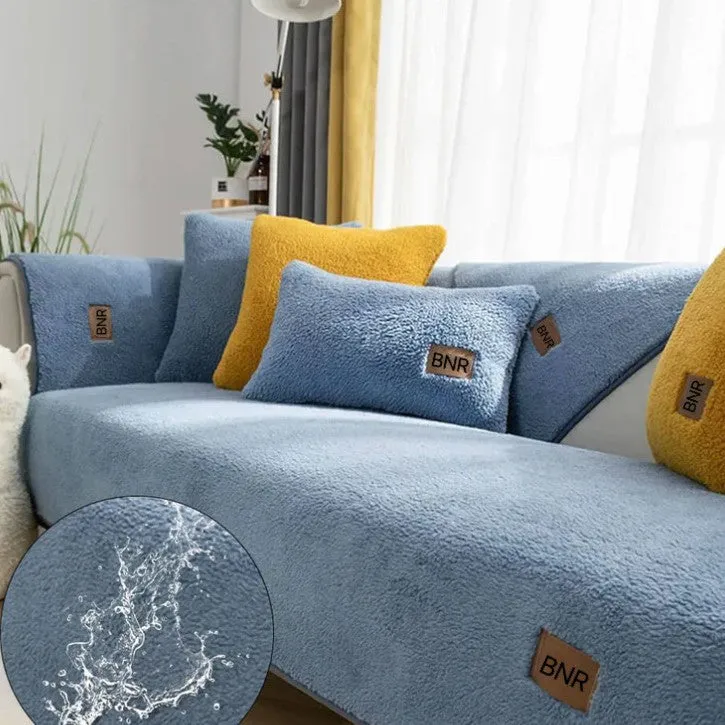 Solid colour lambswool sofa cover draped over a sofa, showing simple style and cloth liner.