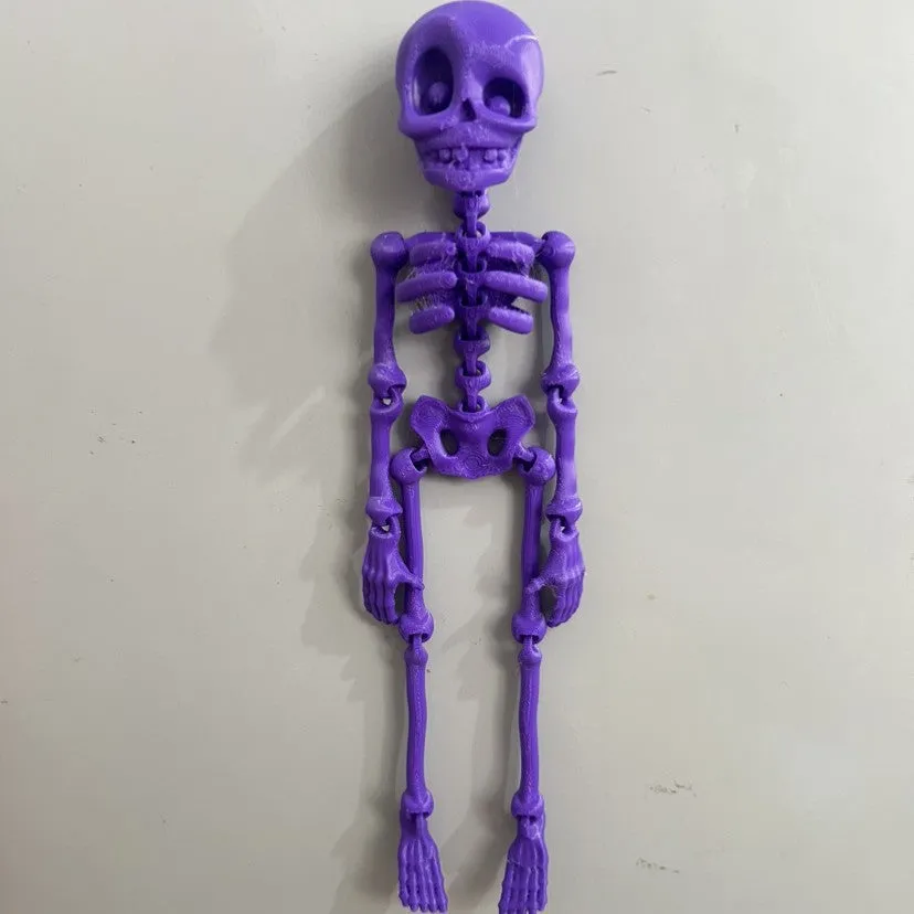 3D printed skull refrigerator magnet in multiple colours measuring 18cm high by 4.5cm wide