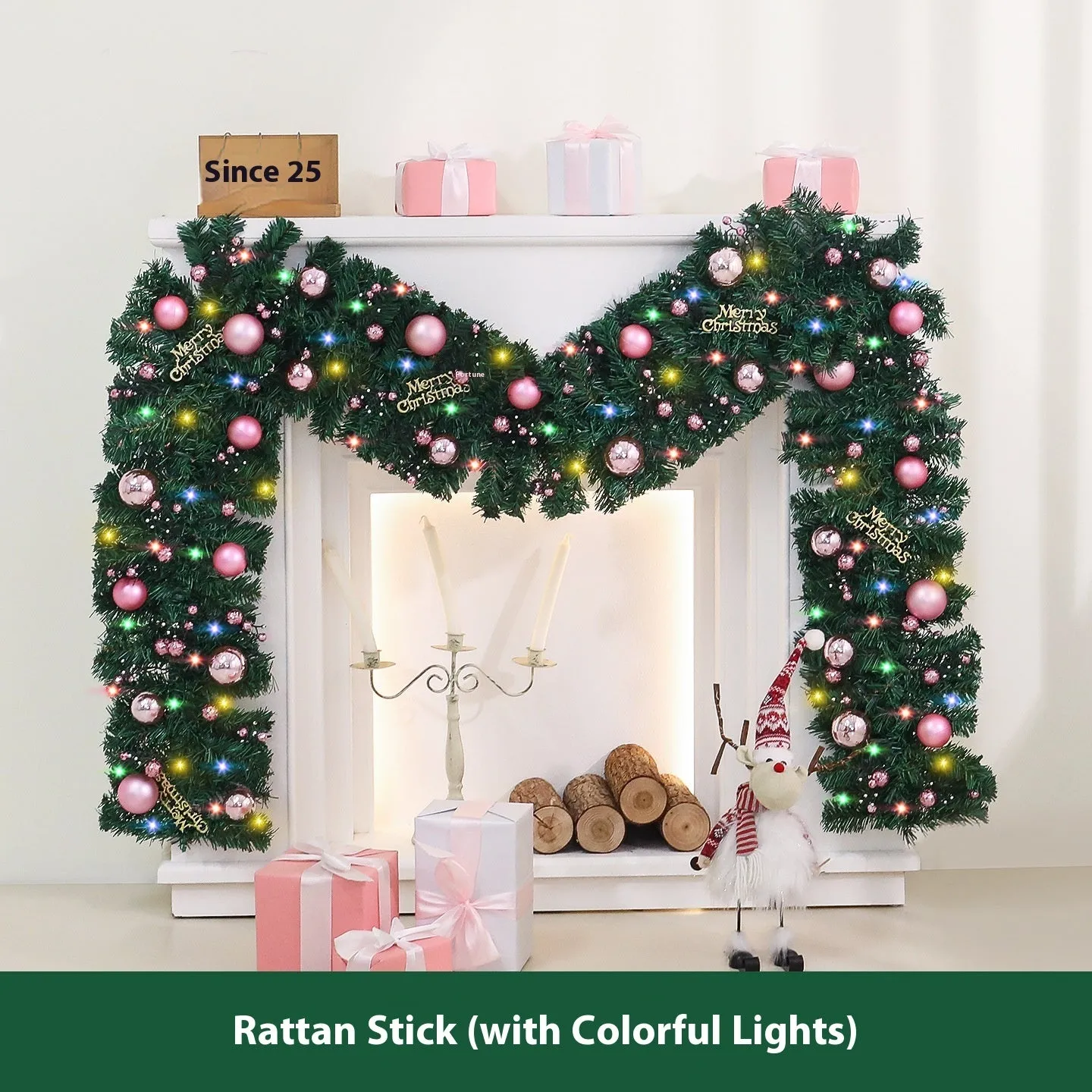 Pink artificial Christmas rattan vine decoration with small fruit clusters and warm white LED lights, coiled on a table.