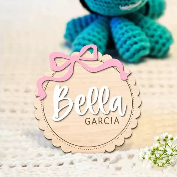 Square wooden baby room ornament with a customised name, shown in two size options.