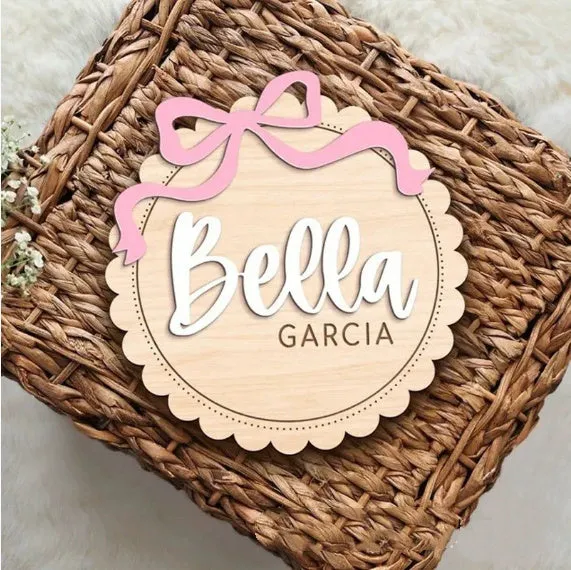 Square wooden baby room ornament with a customised name, shown in two size options.