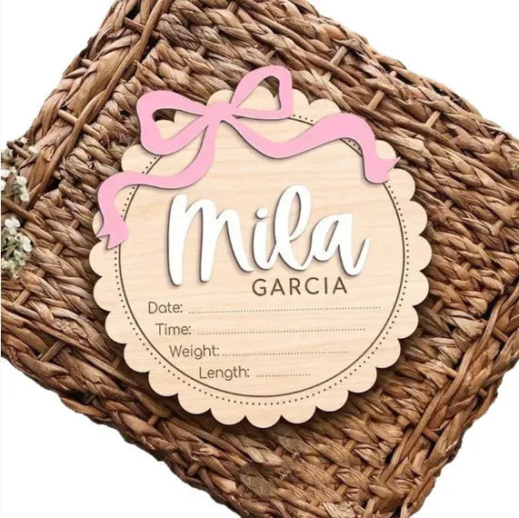 Square wooden baby room ornament with a customised name, shown in two size options.
