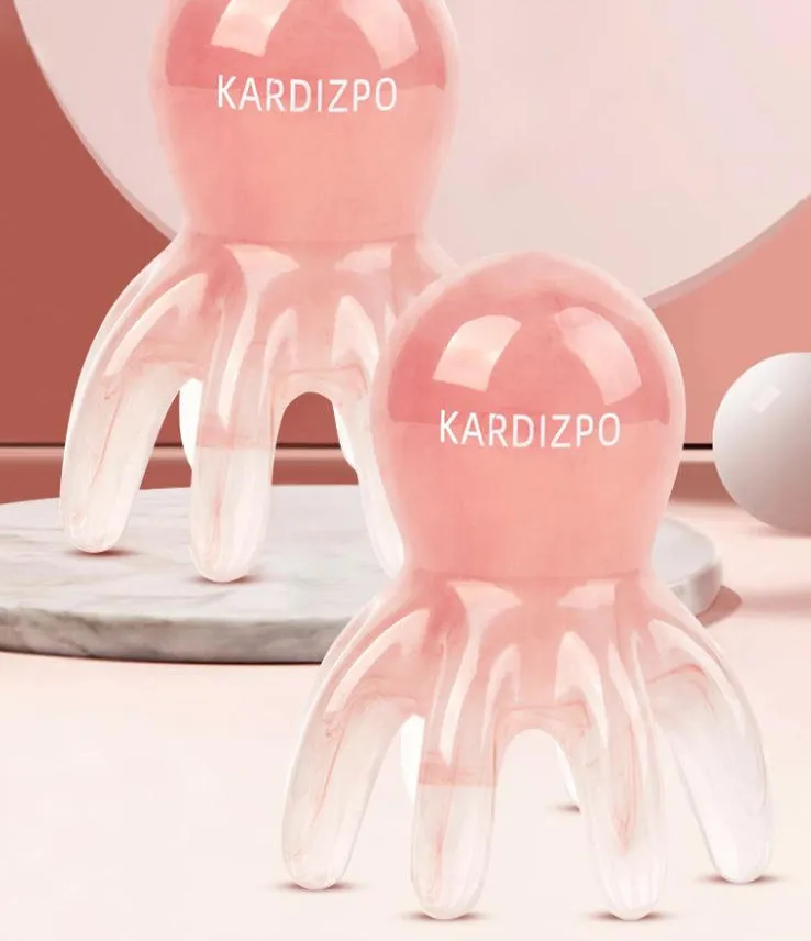 Pink octopus-shaped massage comb for periocular meridian acupressure with curved arms and storage bag