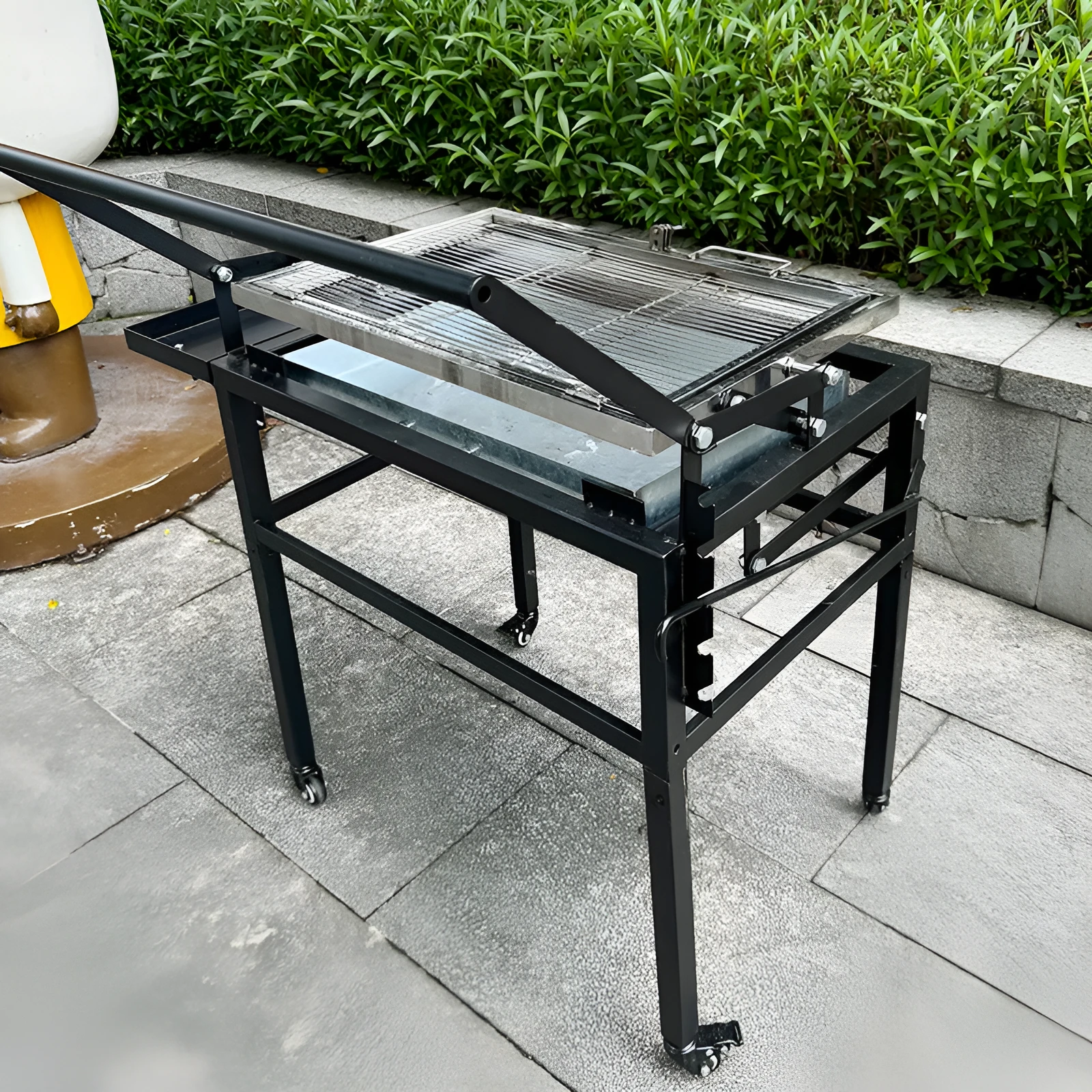 Large foldable portable charcoal BBQ stove with a detachable grill for outdoor cooking.