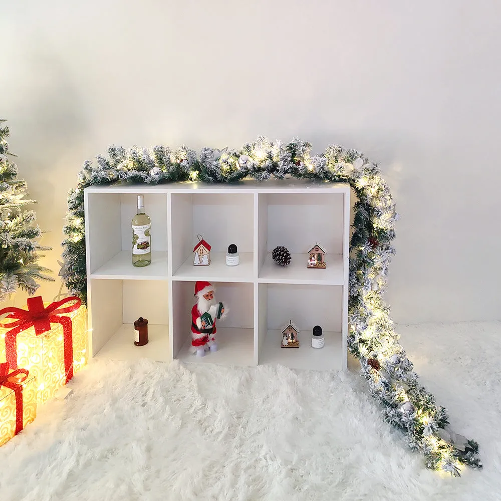 American-style red flocked PVC rattan Christmas garland decoration draped over a mantelpiece.
