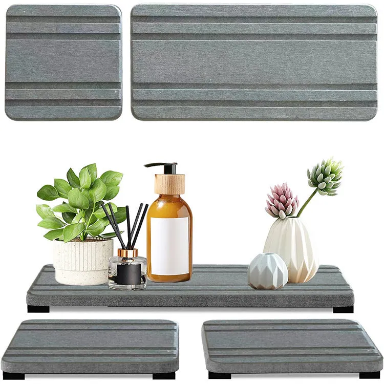 Three square diatomite bathroom draining pads in solid colours on a countertop