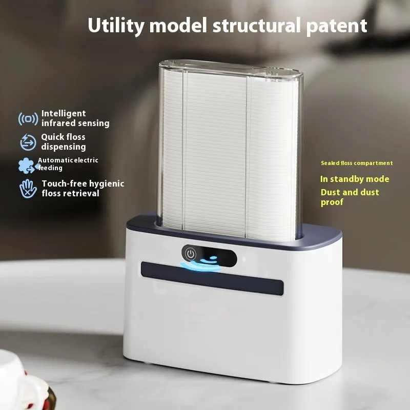 Dark gray automatic electric dental floss box with pop-up floss dispenser on a bathroom counter.