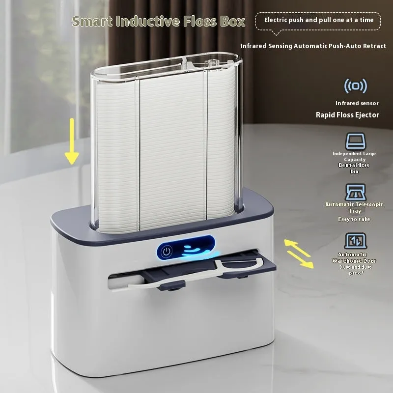 Dark gray automatic electric dental floss box with pop-up floss dispenser on a bathroom counter.