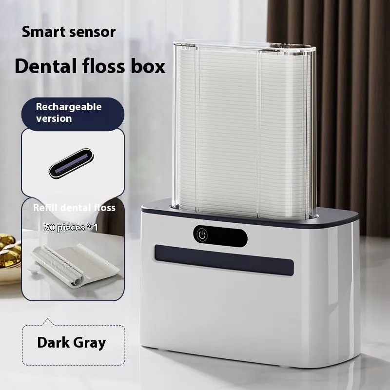 Dark gray automatic electric dental floss box with pop-up floss dispenser on a bathroom counter.