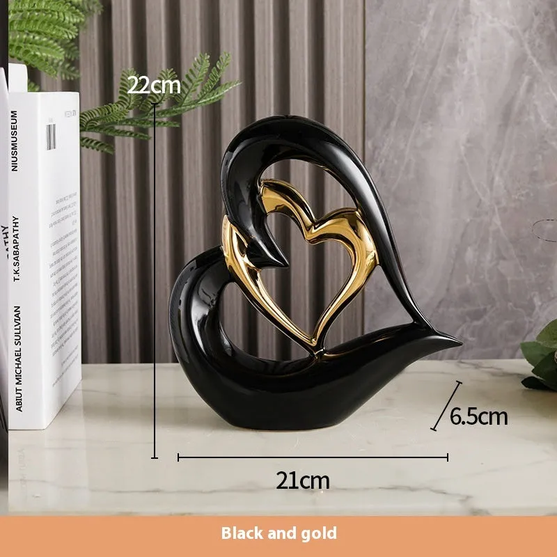 Modern geometric heart ornament in metallic finish displayed on shelf