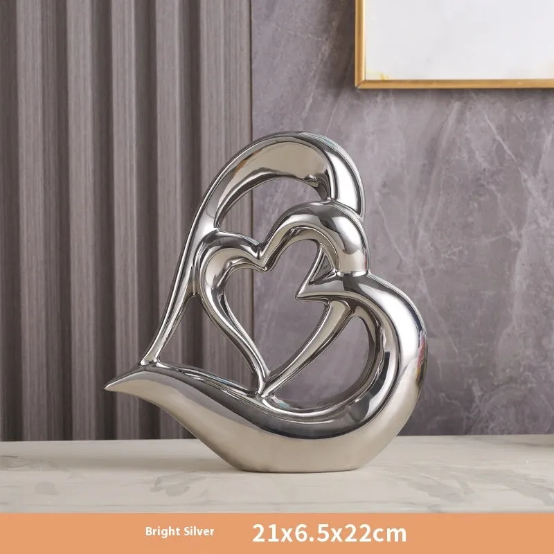 Modern geometric heart ornament in metallic finish displayed on shelf