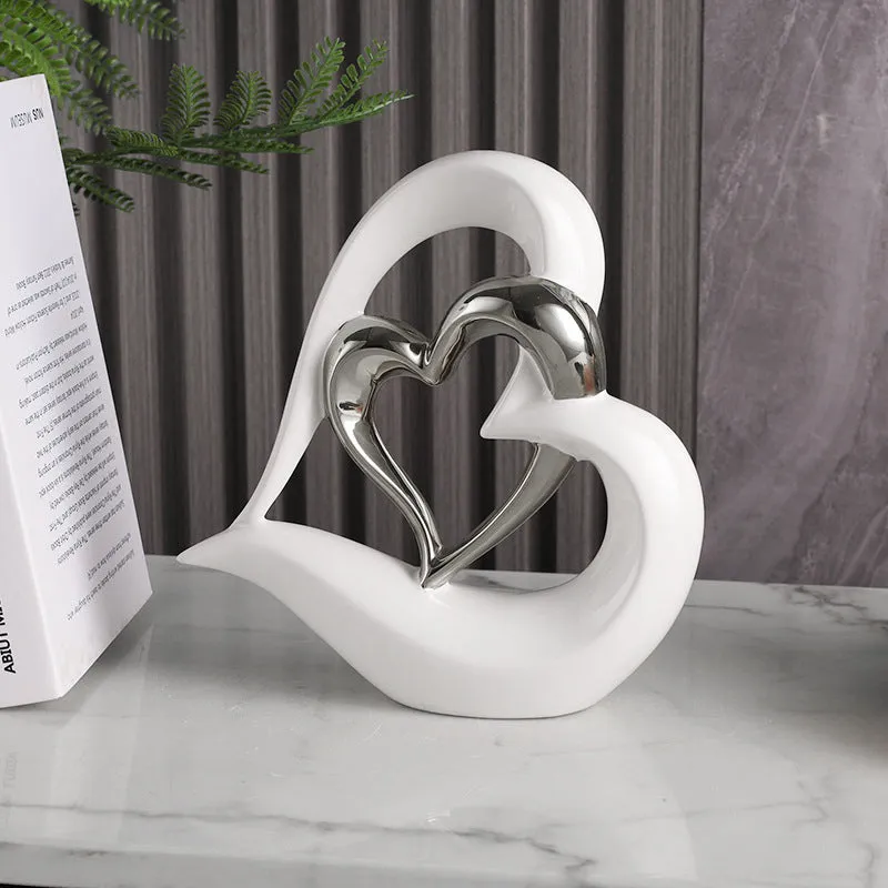 Modern geometric heart ornament in metallic finish displayed on shelf