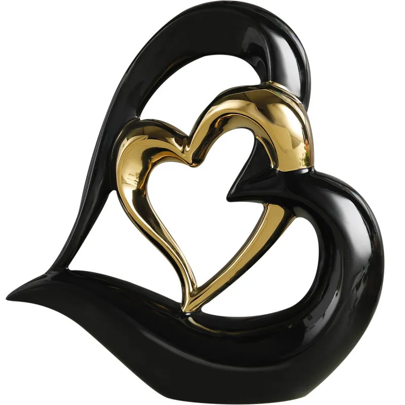 Modern geometric heart ornament in metallic finish displayed on shelf