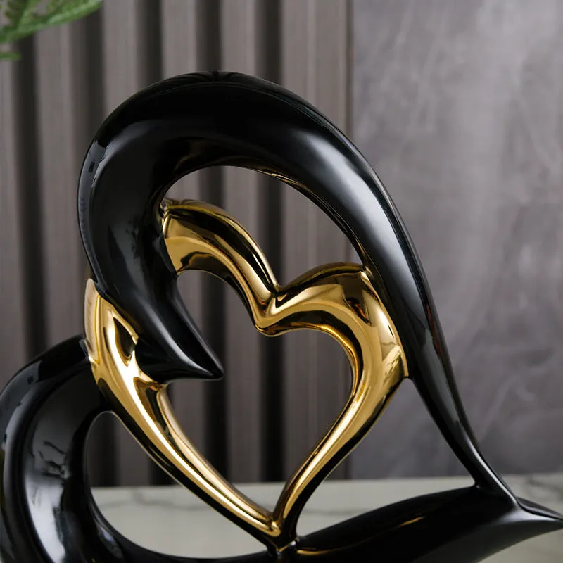 Modern geometric heart ornament in metallic finish displayed on shelf