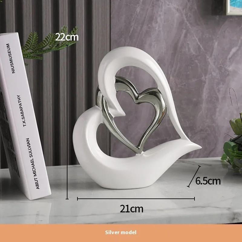 Modern geometric heart ornament in metallic finish displayed on shelf