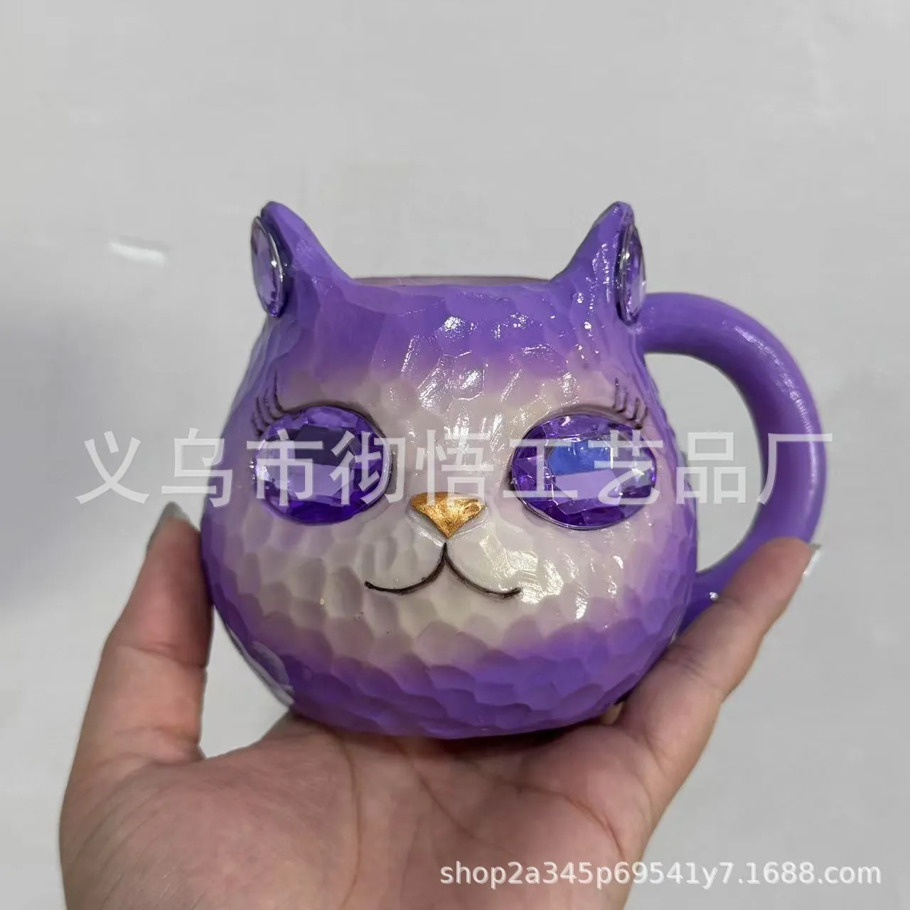 Colourful resin cat cup figurine on a shelf, shown in purple, green, blue, and pink colour options.