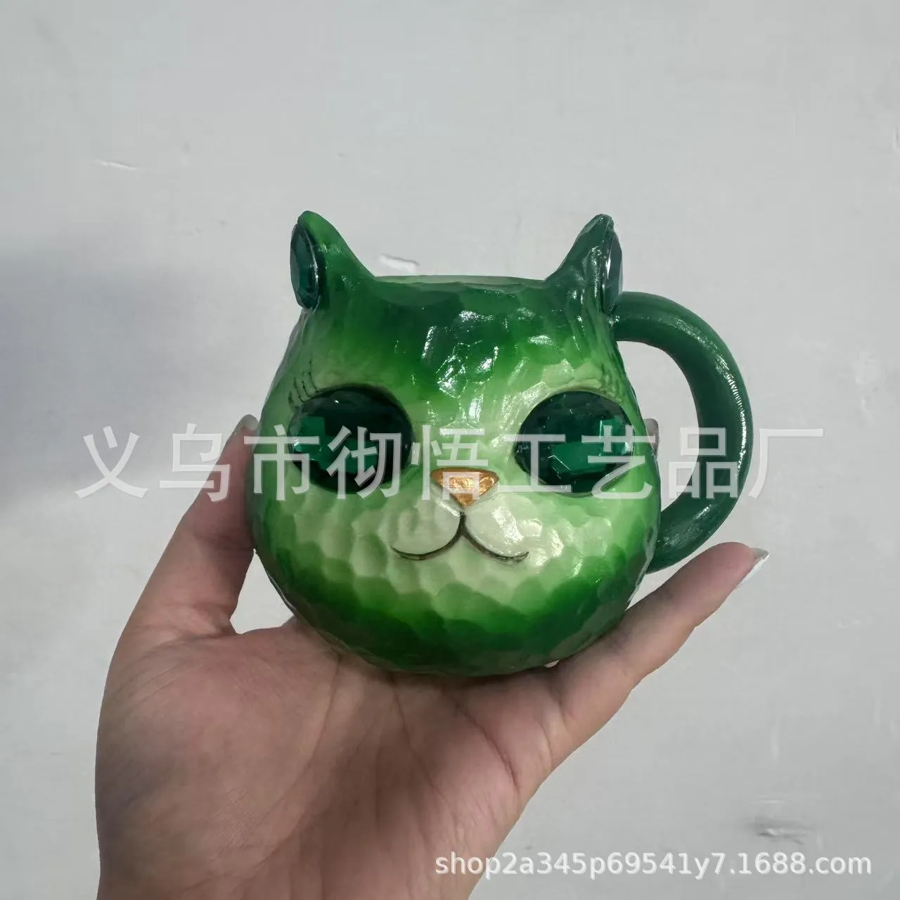 Colourful resin cat cup figurine on a shelf, shown in purple, green, blue, and pink colour options.