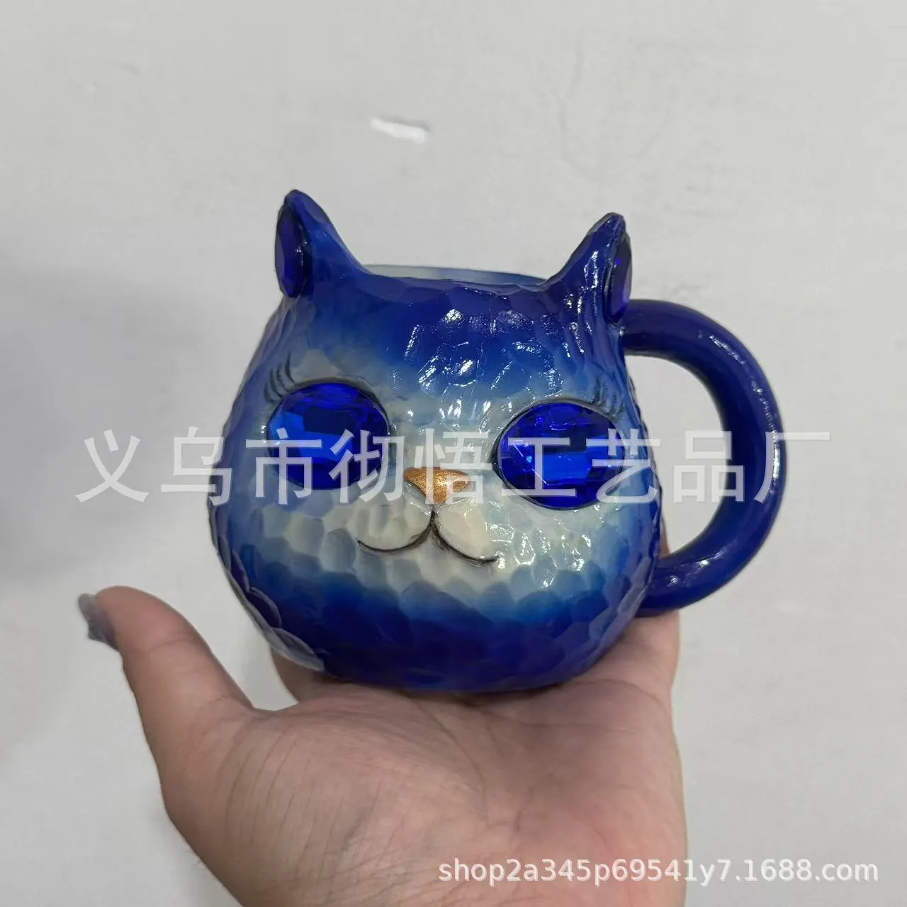 Colourful resin cat cup figurine on a shelf, shown in purple, green, blue, and pink colour options.