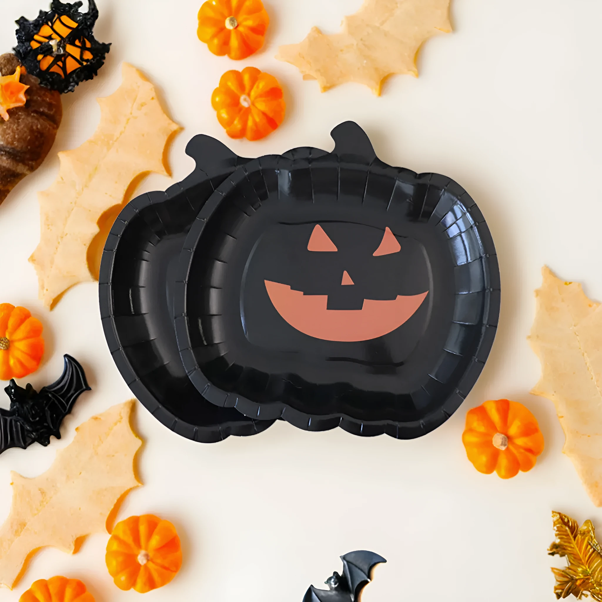 Black Halloween disposable paper plates with pumpkin designs, 9-inch diameter