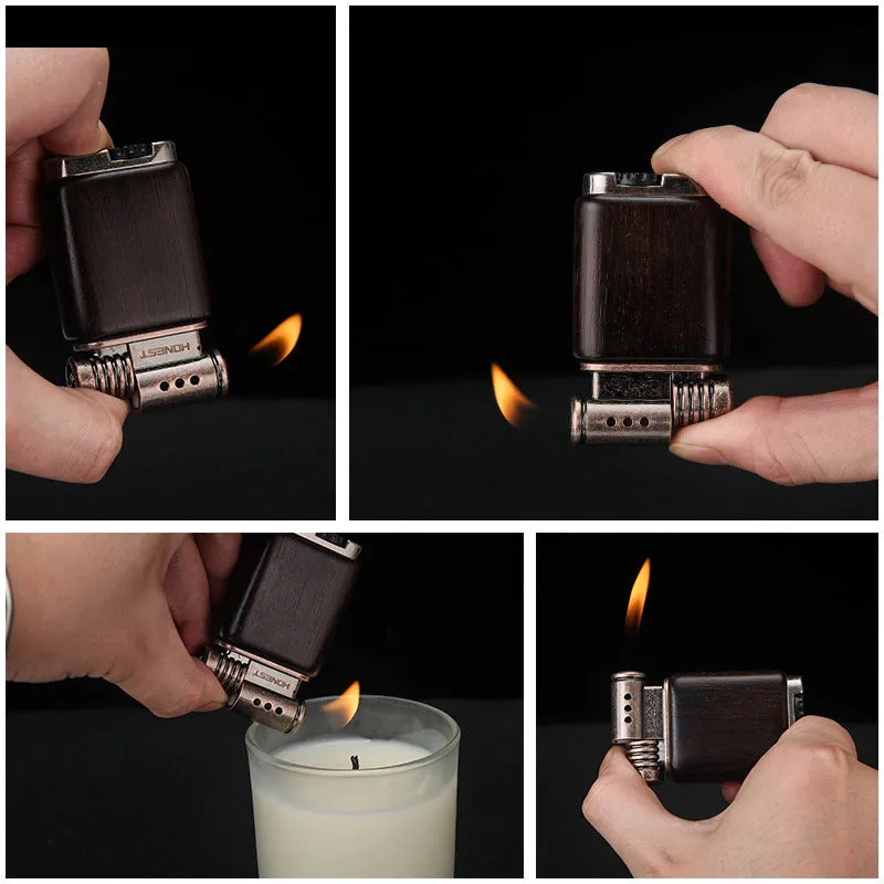 Decorative rosewood and blackwood gas lighter with sun face engraving on metal body.