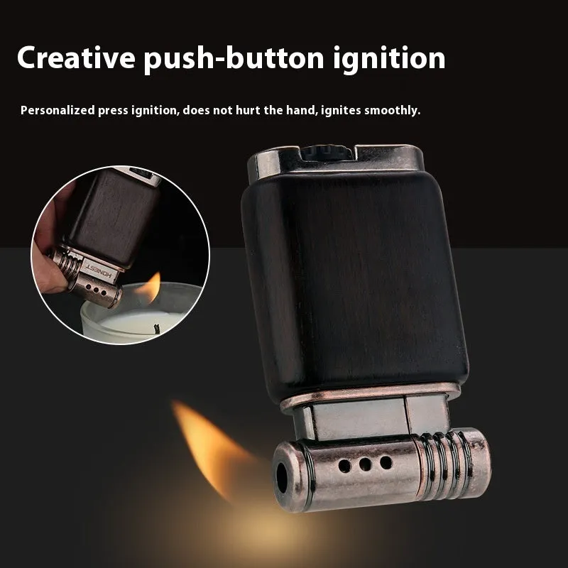 Decorative rosewood and blackwood gas lighter with sun face engraving on metal body.