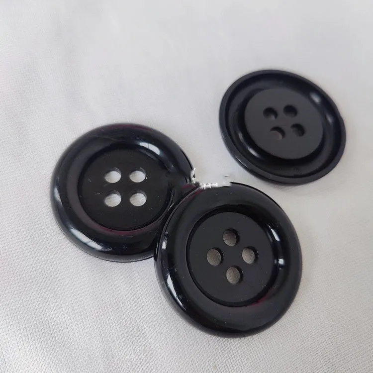 Oversized round edge plastic button with four holes in various colours and diameter sizes