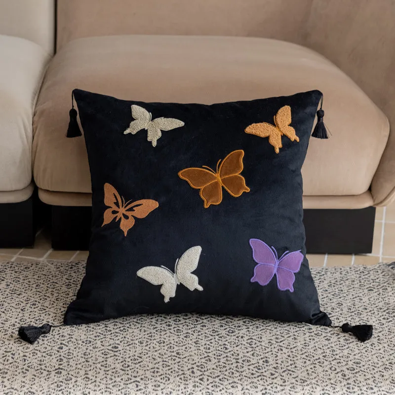 Square beige cushion with embroidered Chinese-style butterfly design.