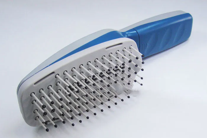 A white pet comb with a removable brush head and a handle housing negative ion and active oxygen technology.