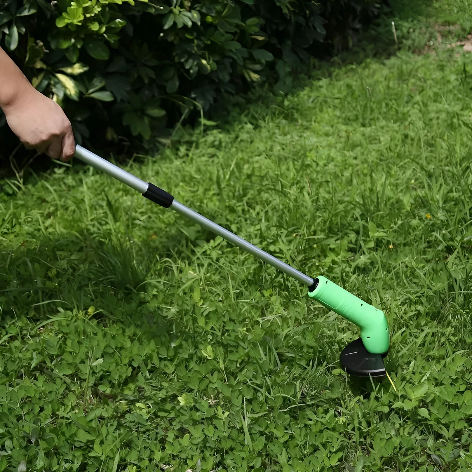 Cordless lawn trimmer tool with extension pole and protective debris shield for garden maintenance