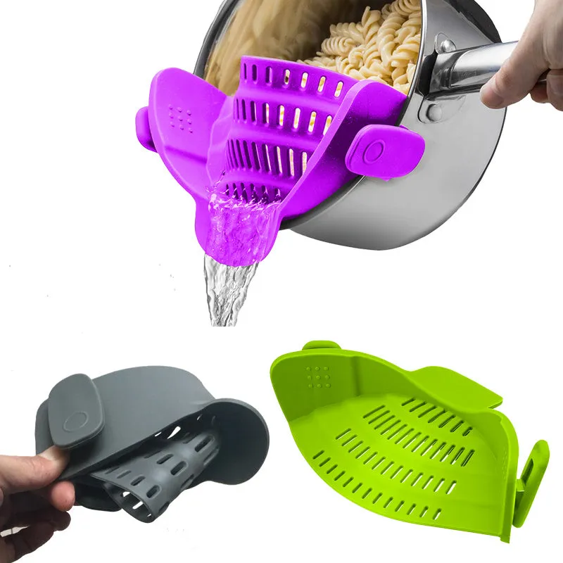 Silicone clip-on kitchen strainer with stainless steel frame attached to pot rim for draining liquids