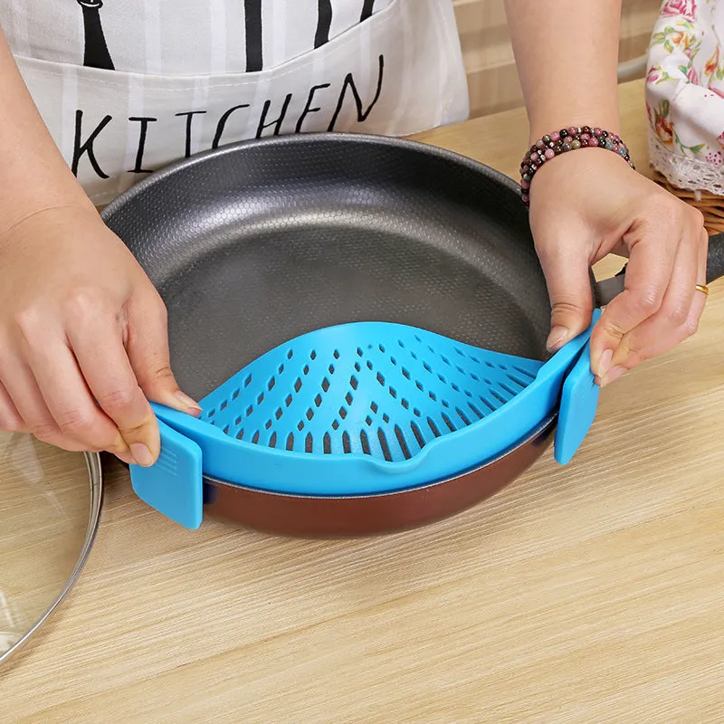 Silicone clip-on kitchen strainer with stainless steel frame attached to pot rim for draining liquids