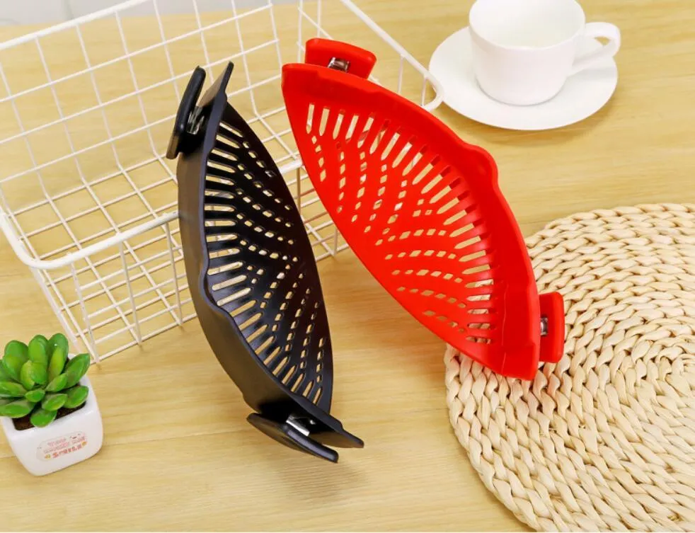 Silicone clip-on kitchen strainer with stainless steel frame attached to pot rim for draining liquids