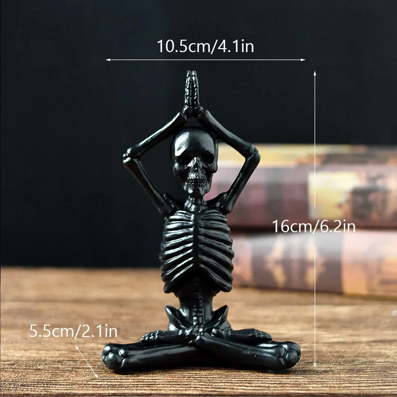 Hand-painted resin yoga pose skull skeleton ornament measuring 10.5-11cm wide on wooden desktop