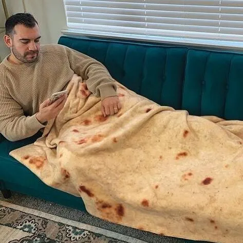 Round flannel burrito blanket with food-themed printing, shown in coral fleece fabric.