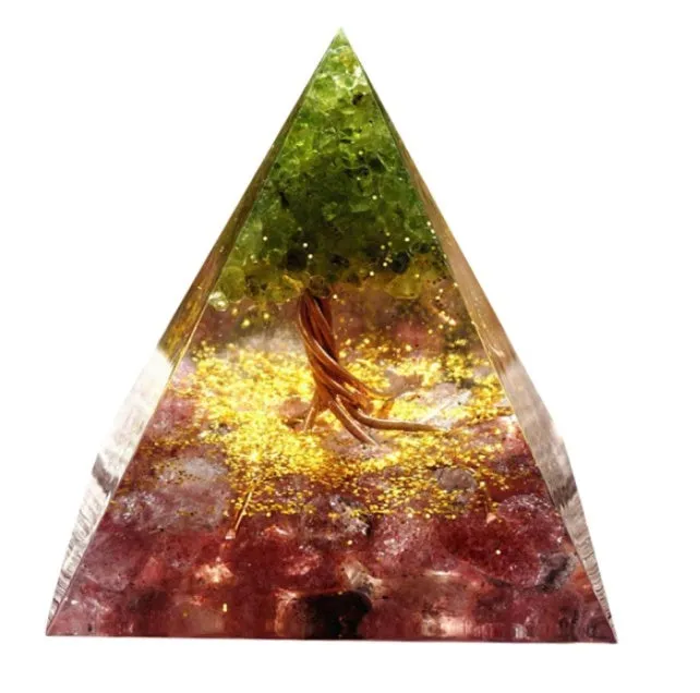 Small 6cm high clear epoxy resin pyramid ornament filled with colourful natural crystal gravel on a shelf.