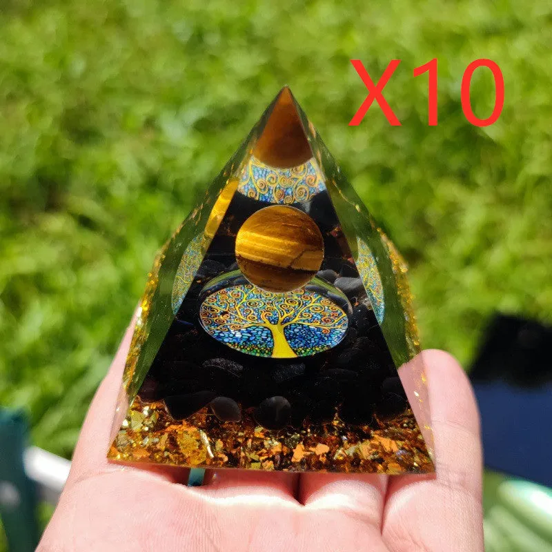Small 6cm high clear epoxy resin pyramid ornament filled with colourful natural crystal gravel on a shelf.