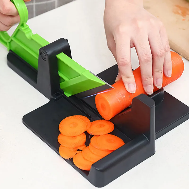 Green vegetable cutter with stainless steel blades for carrot and potato slicing in kitchen